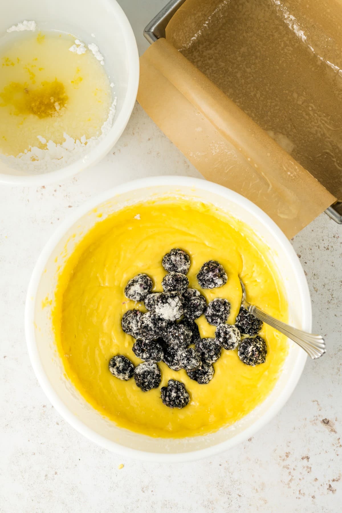 Batter in a bowl with berries. 