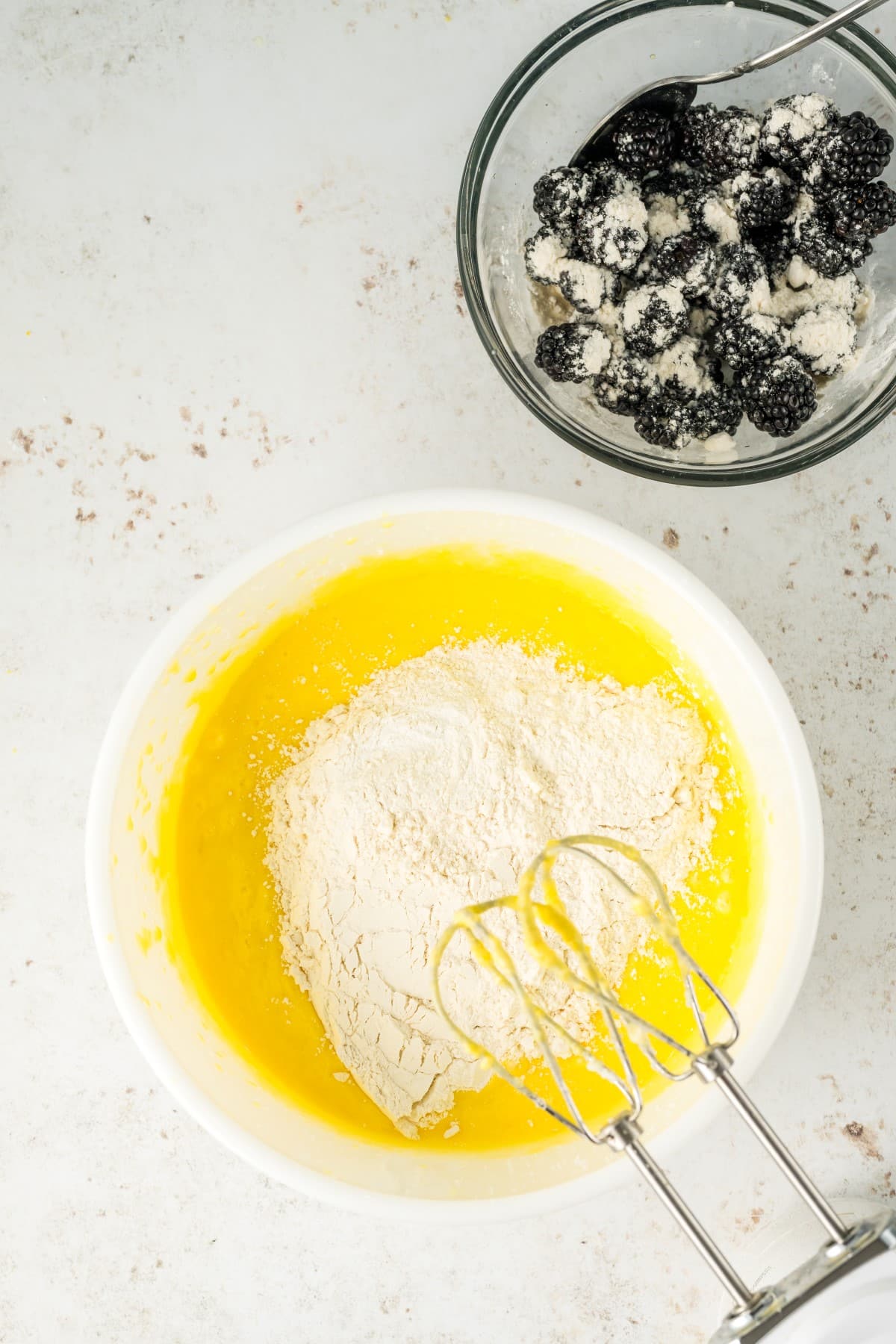 Adding dry ingredients to the batter. 