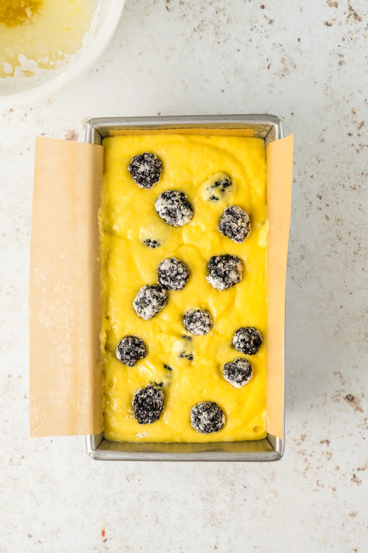 Batter with berries on the top ready for the oven. 