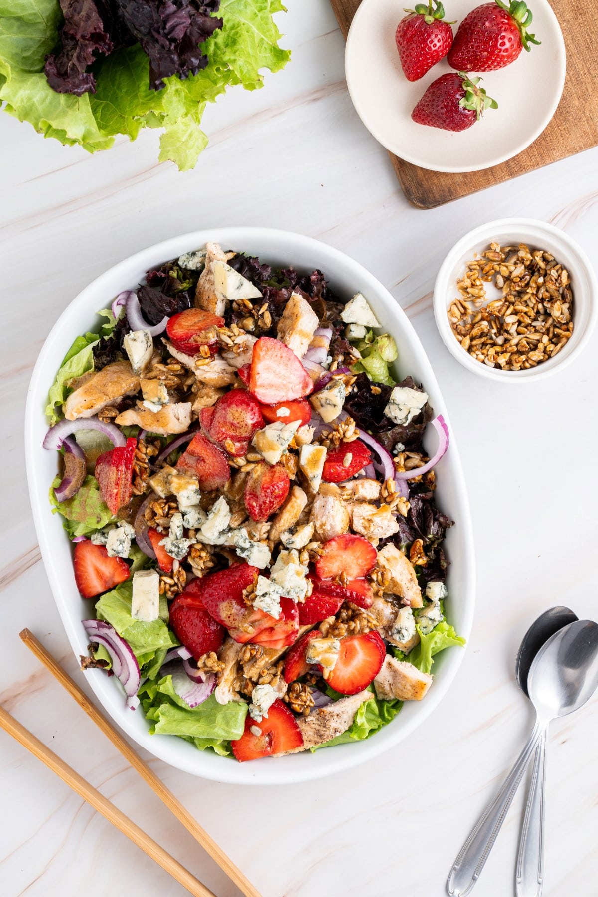 Get outside and enjoy the day with these 50 Picnic Basket Essentials. There is something for everyone to pack the perfect picnic and enjoy family time and the great outdoors. Strawberry chicken salad in a white serving bowl.