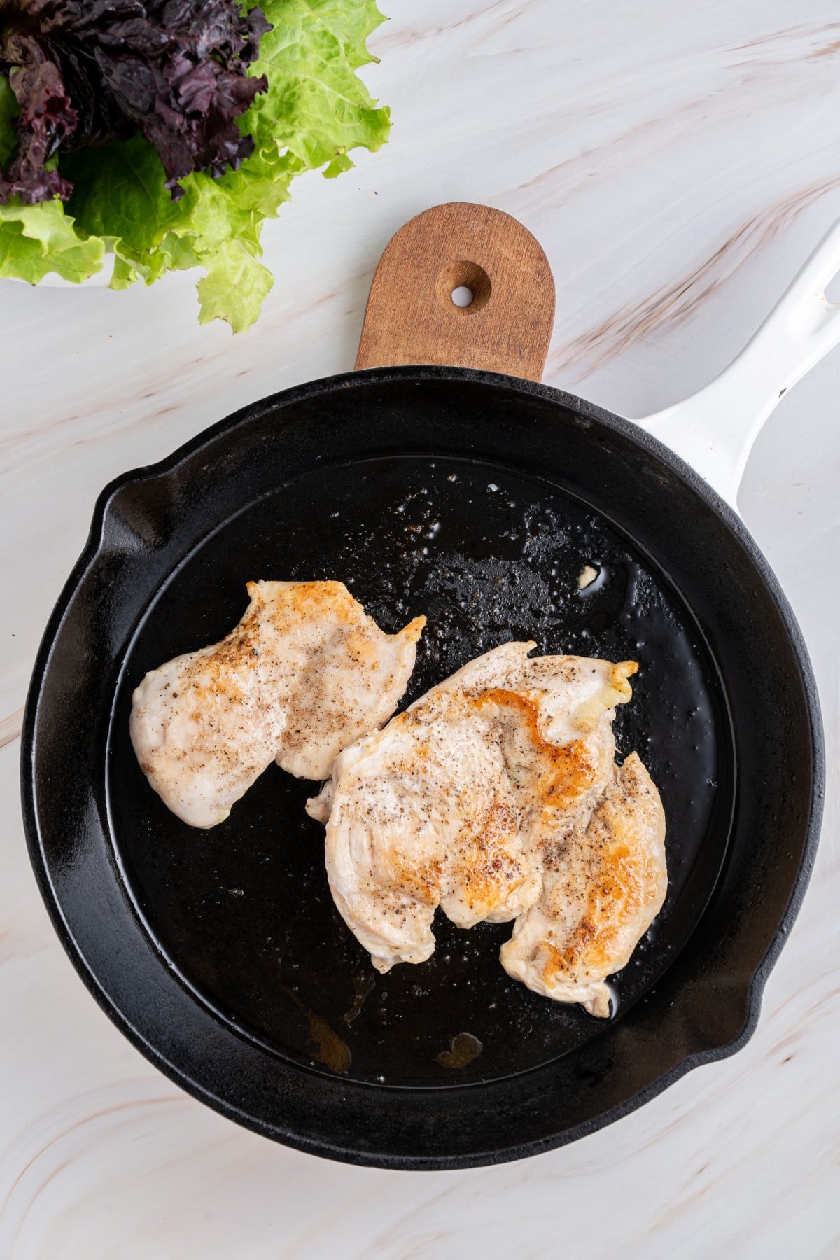 Chicken cooked in a cast iron skillet. 