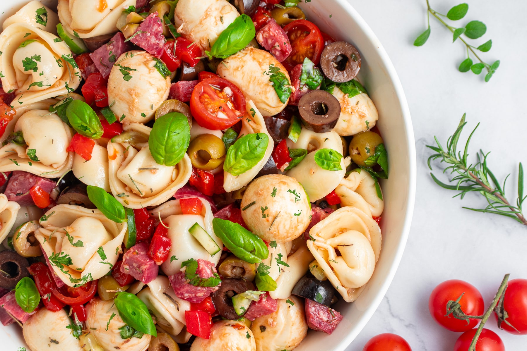 Cheese tortellini pasta salad in a horizontal picture. 