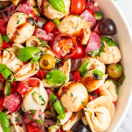 Overhead close-up of the partial bowl of Tortellini Pasta Salad.