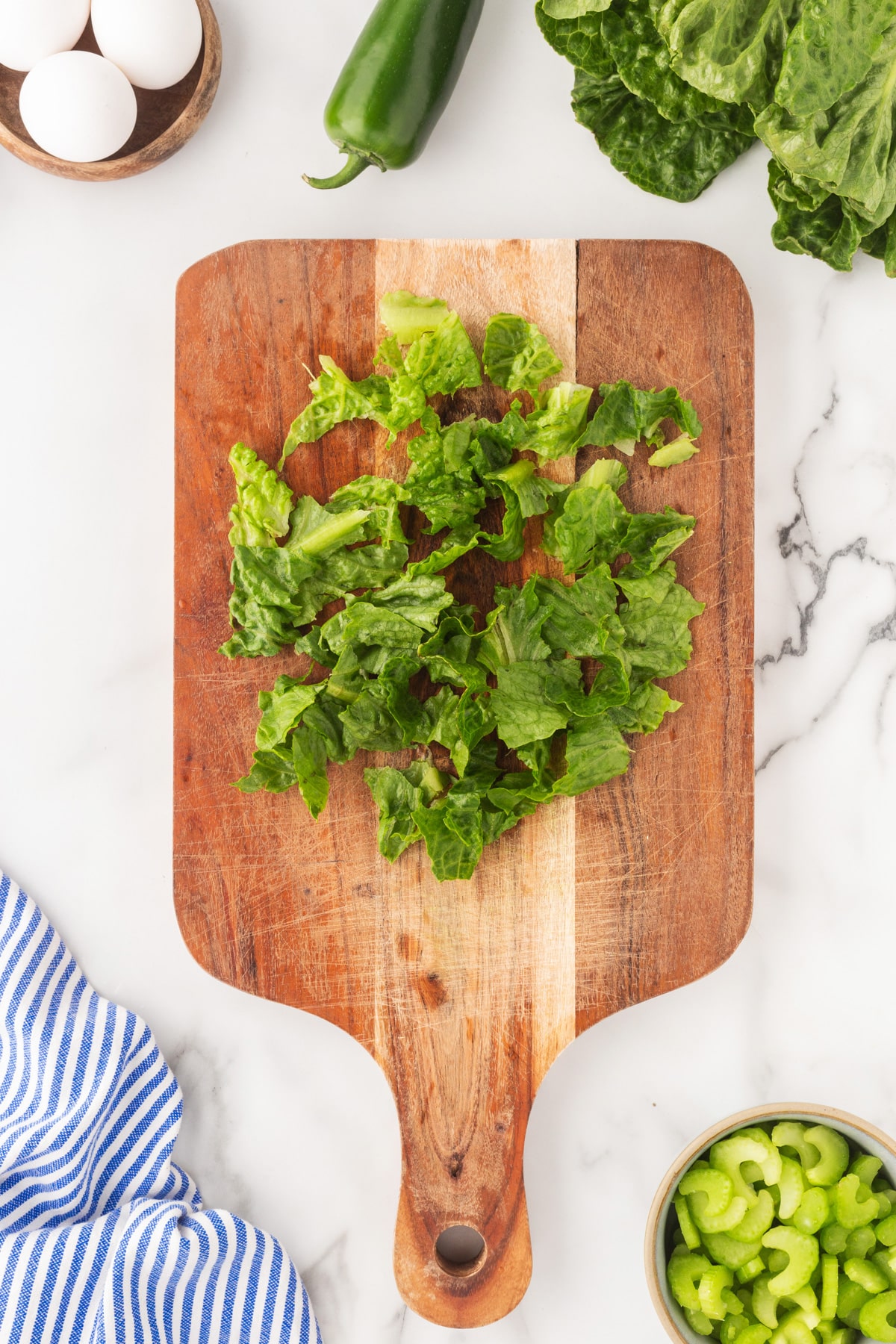 Torn romaine on a wood board. 