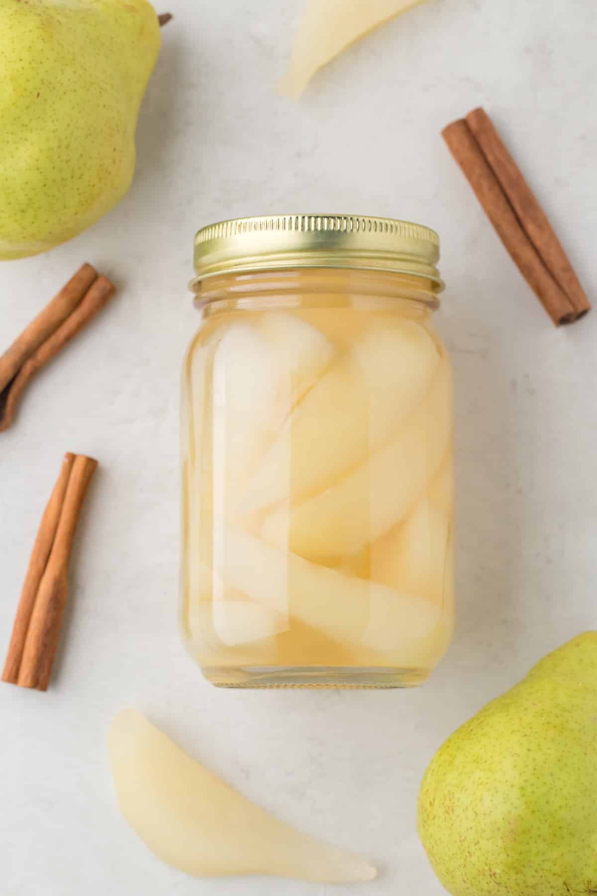 Jar of canned pears lying flat. 