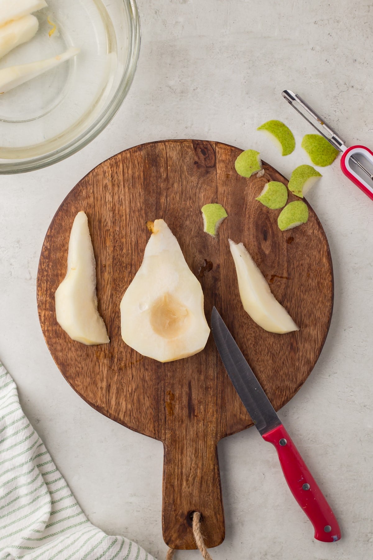 Sliced pear on a wooden cutting board.