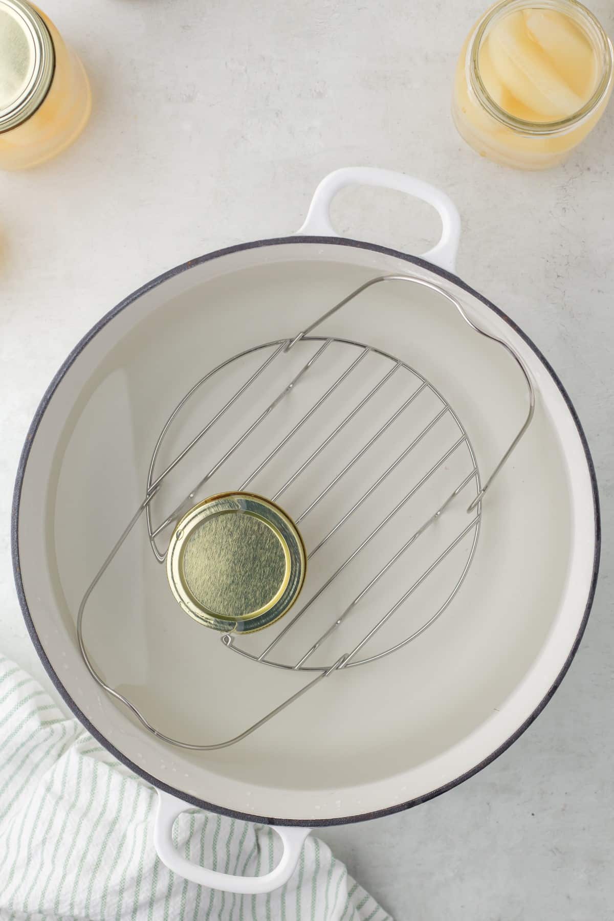 Showing a jar in a water bath canner. 