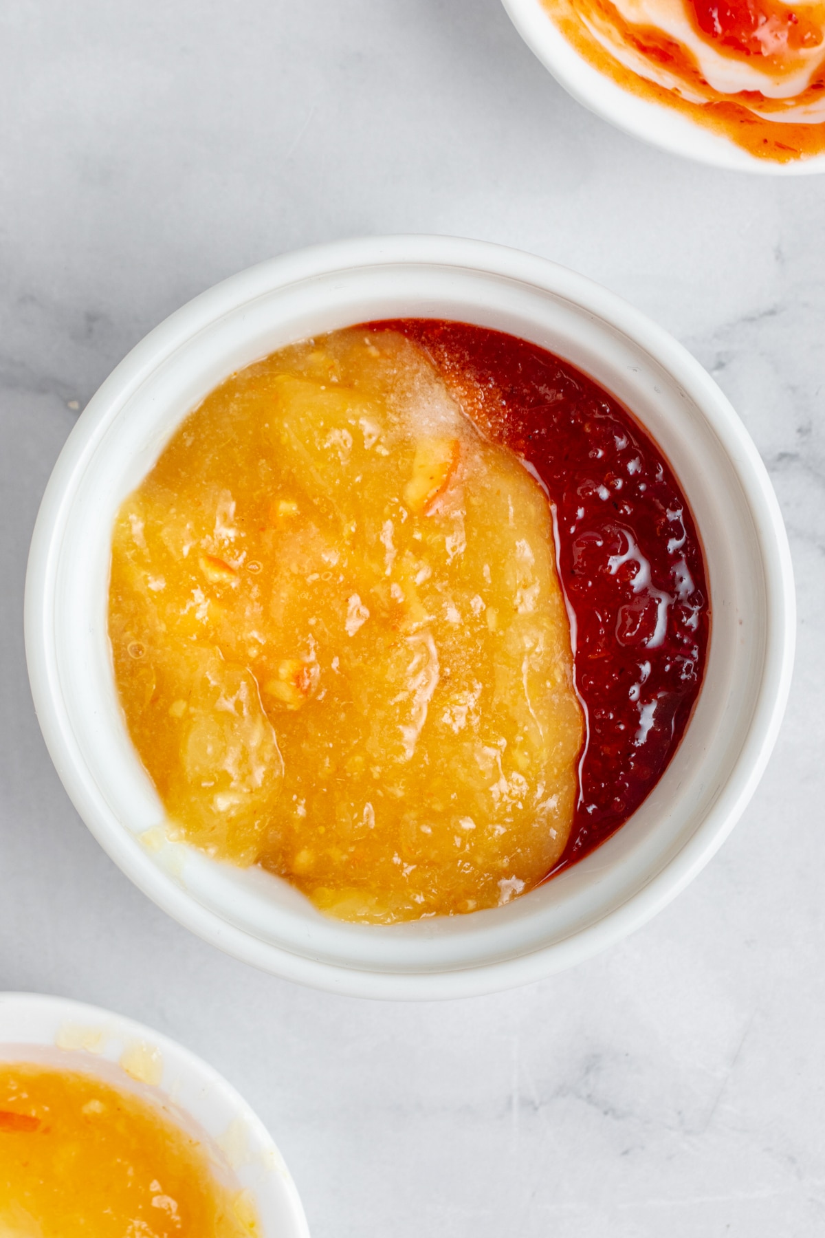 Sweet chili and apricot dipping sauce in a small bowl.