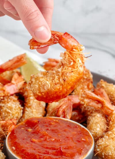 Dipping a shrimp in the sauce.