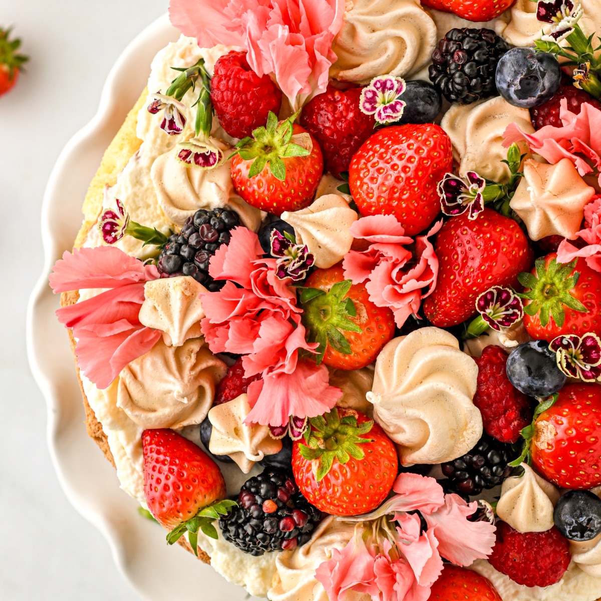 Square photo of the top of an Eton Mess Cake. 