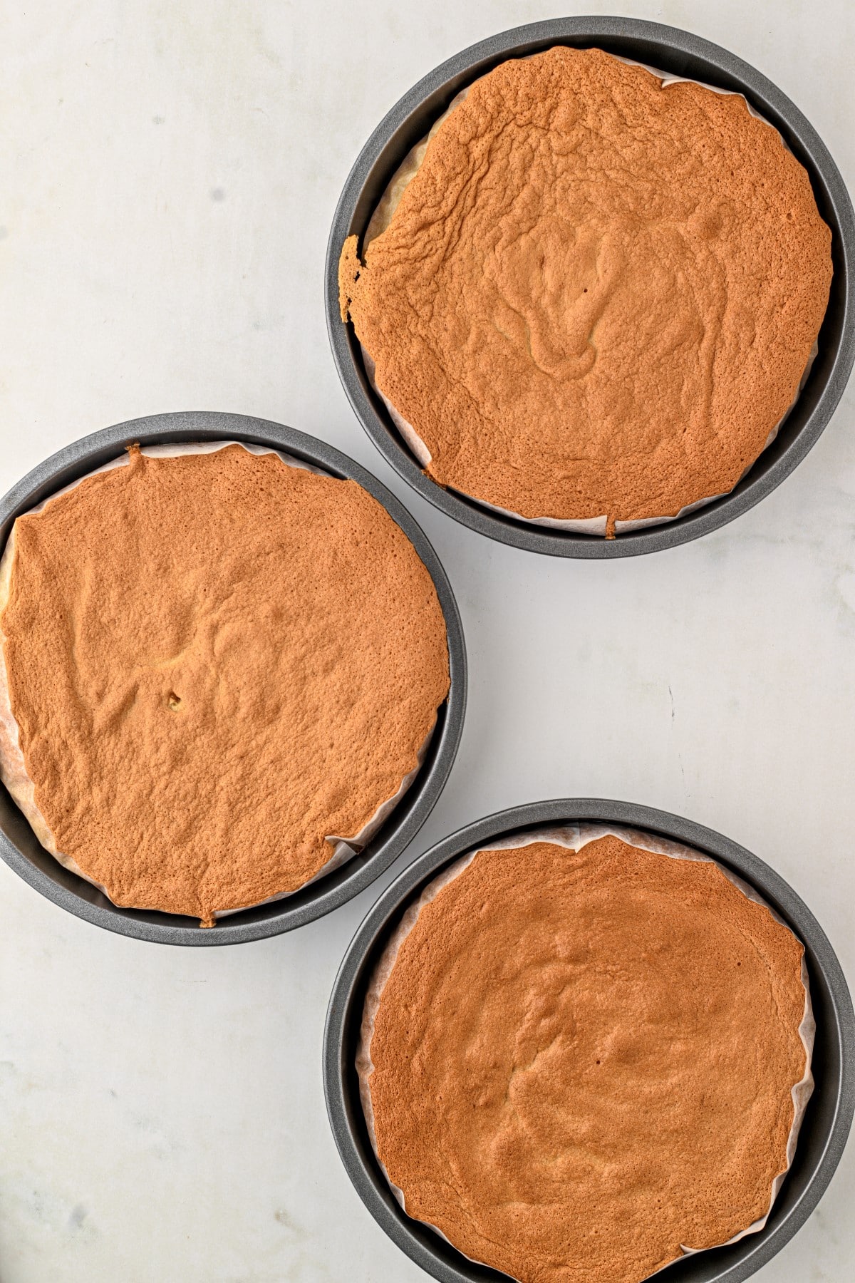 Finished cakes still in the pans from the oven. 