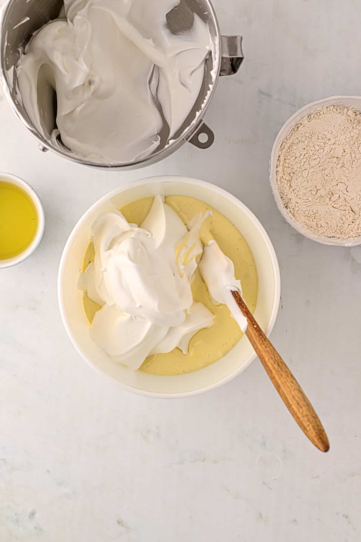 Adding in half of the egg whites. 