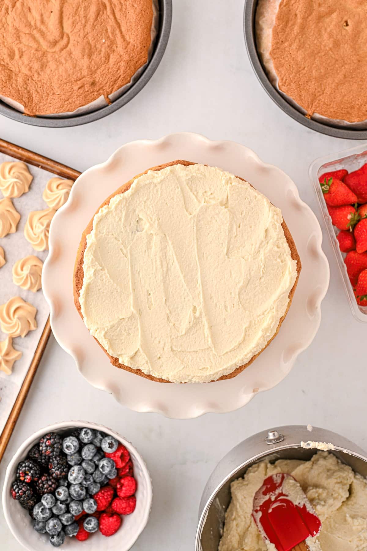 First layer of cake topped with whipped cream. 