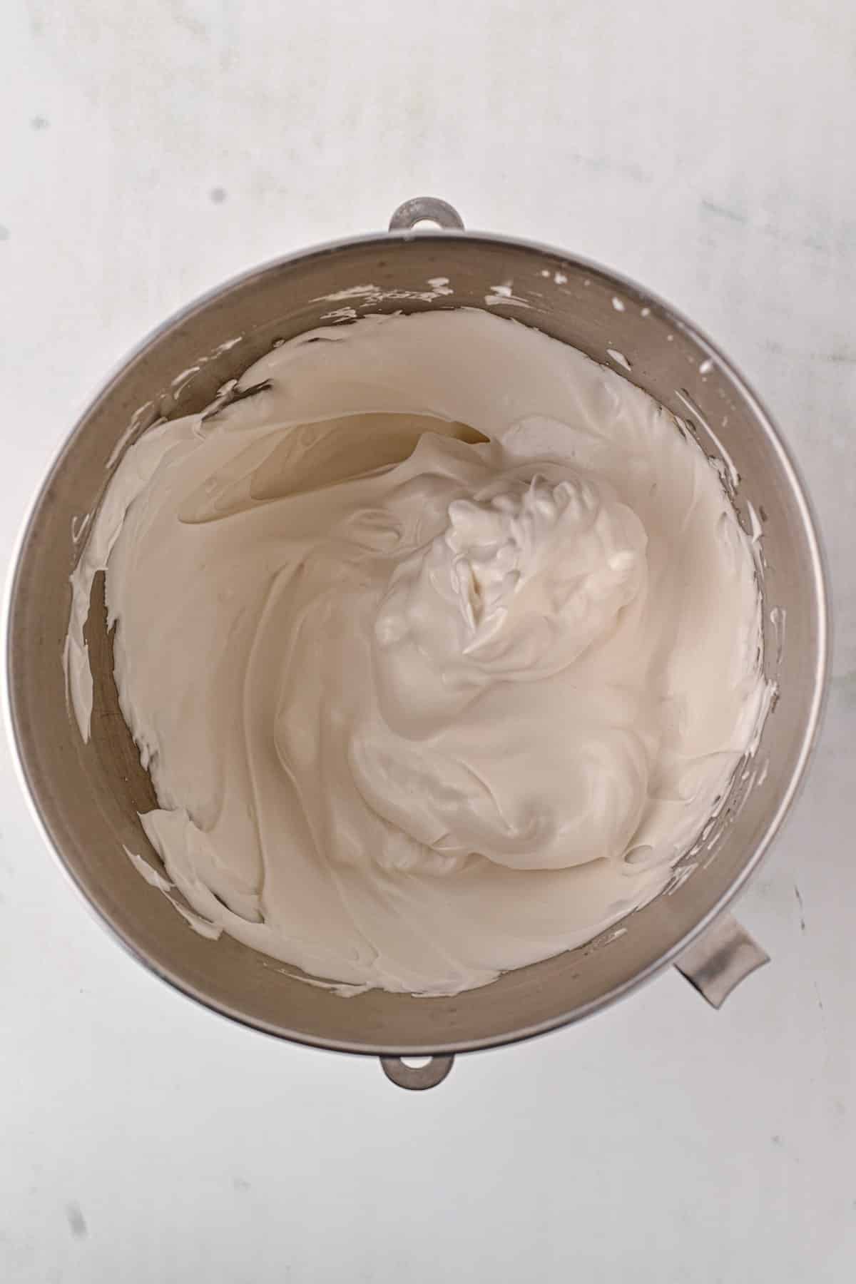 Egg whites beaten in a bowl. 