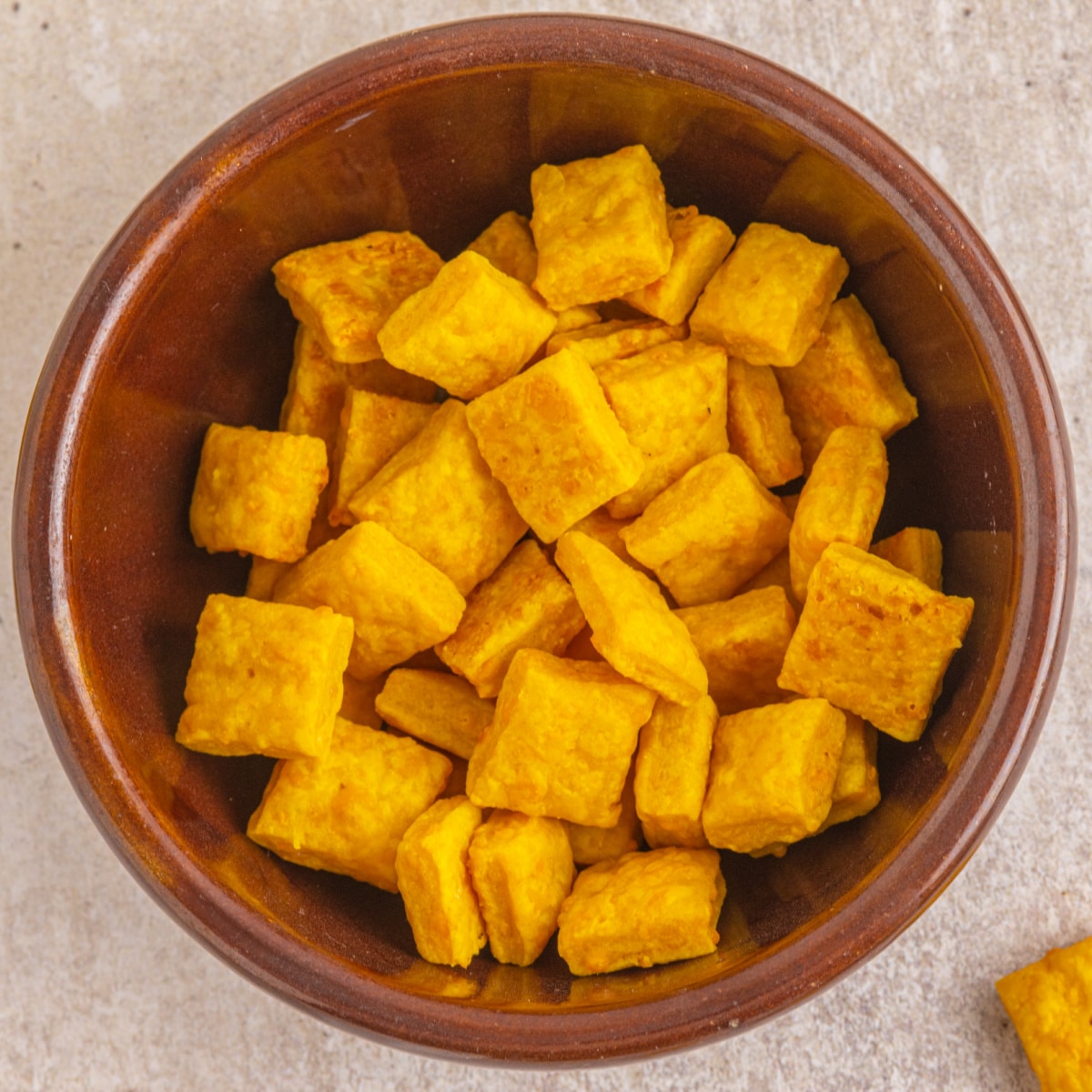 Overhead shot of cheese snacks in a bowl.