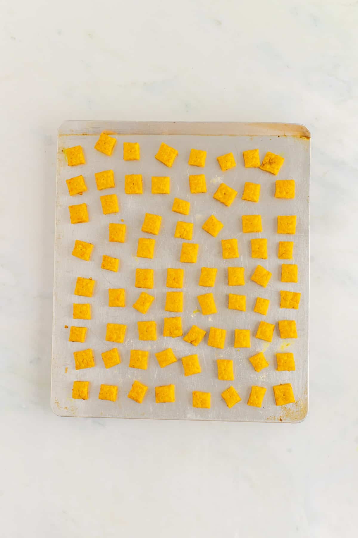 Baked Homemade Cheez-Its on a baking sheet. 