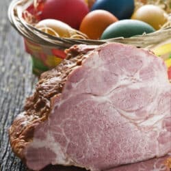 Ham with Easter eggs in the background.