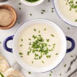 Overhead of two bowls of vichyssoise.