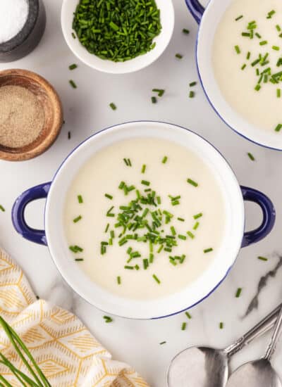 Overhead of two bowls of vichyssoise.