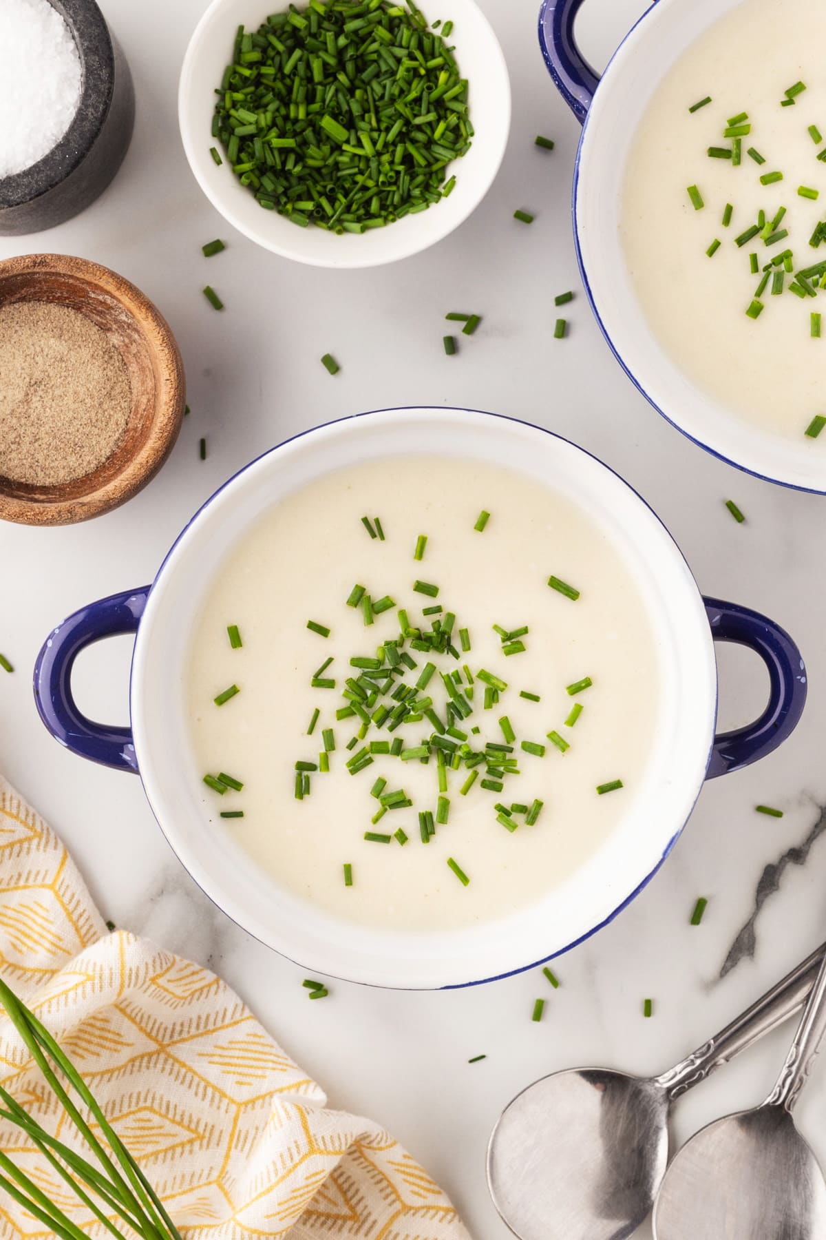Close up bowls of Julia Child's Vichyssoise with chopped chives on top. 