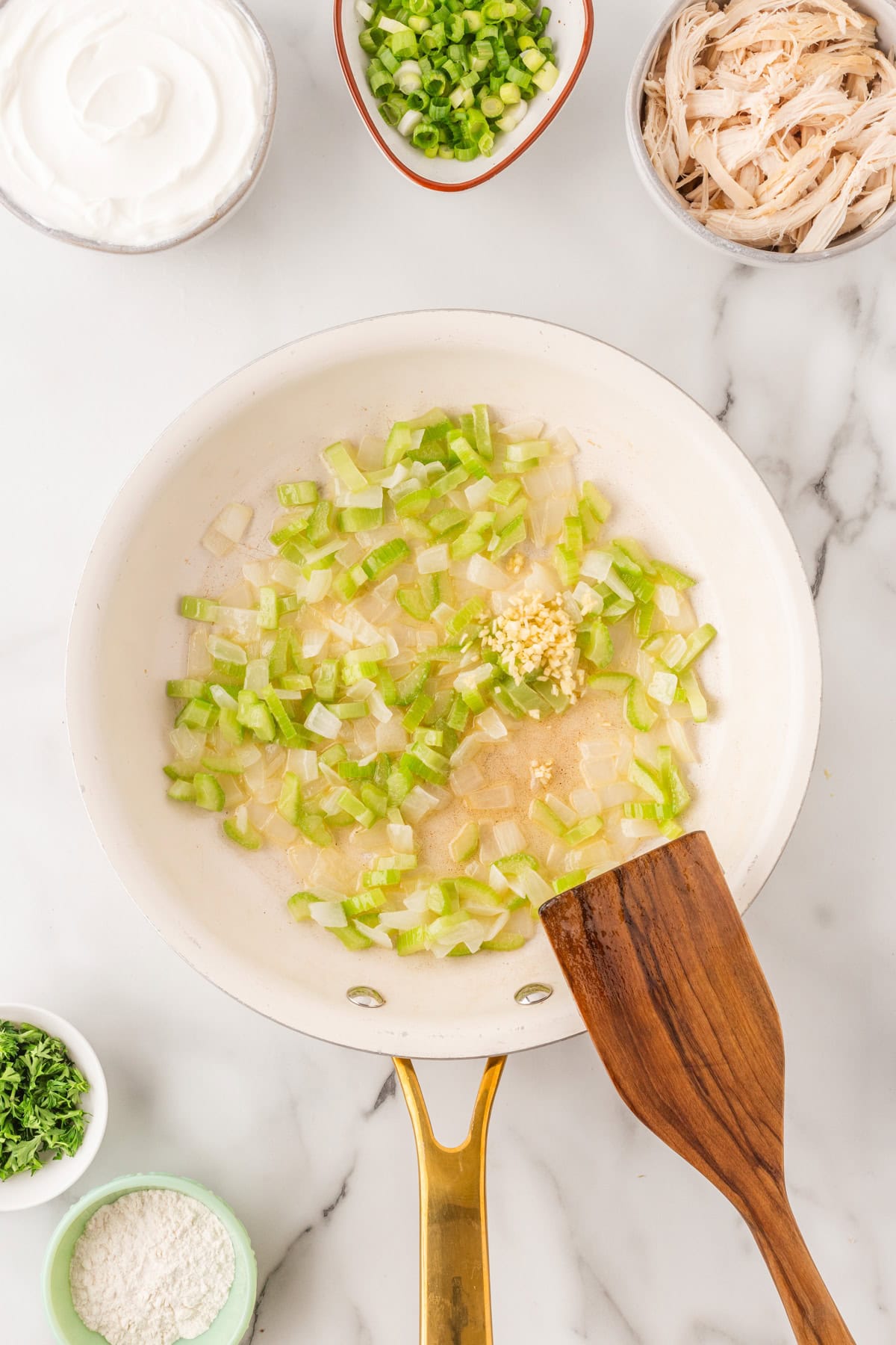 Adding garlic to the veggies. 