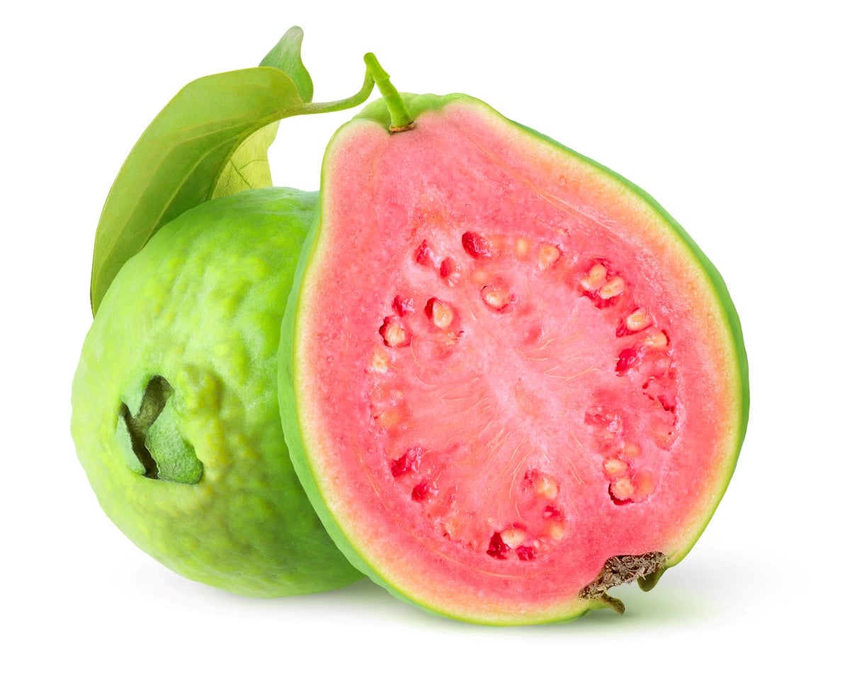 Cut guava tropical fruits with green skin and pink flesh isolated on white background.