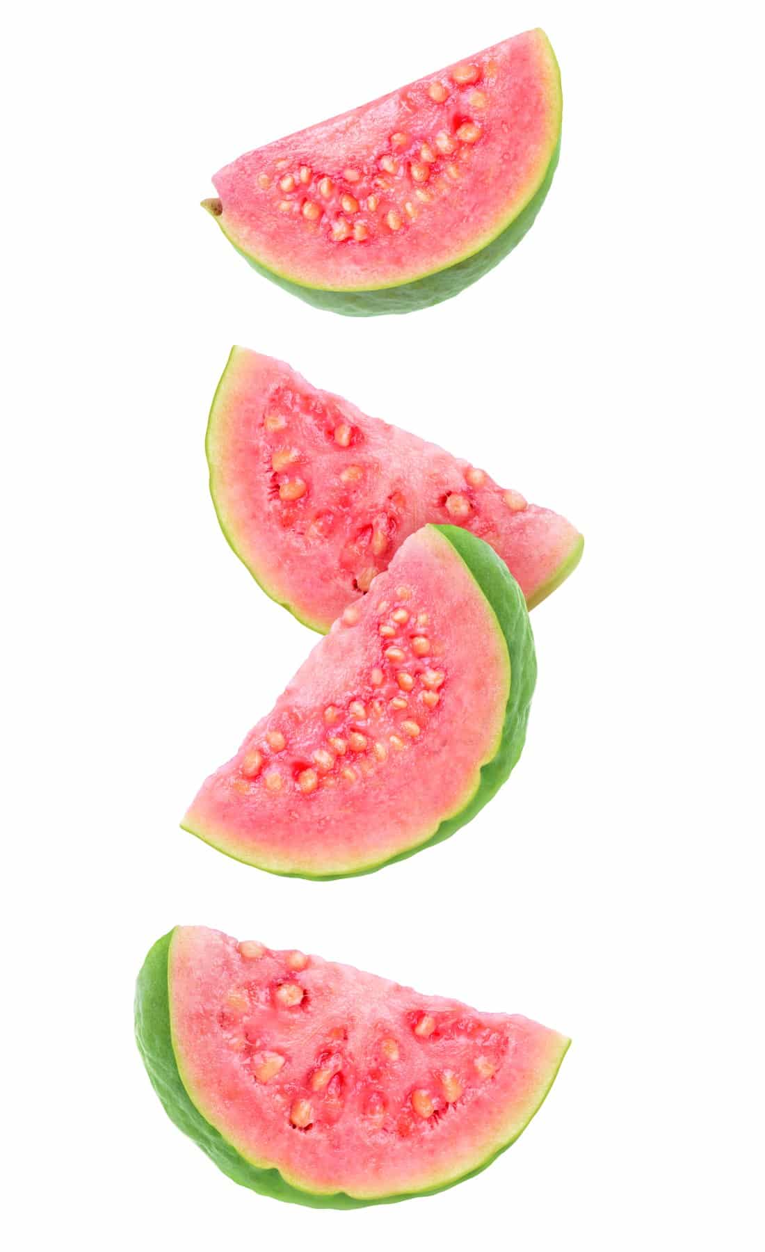 Isolated guava slices. Four wedges of green pink fleshed guava on a white background. 