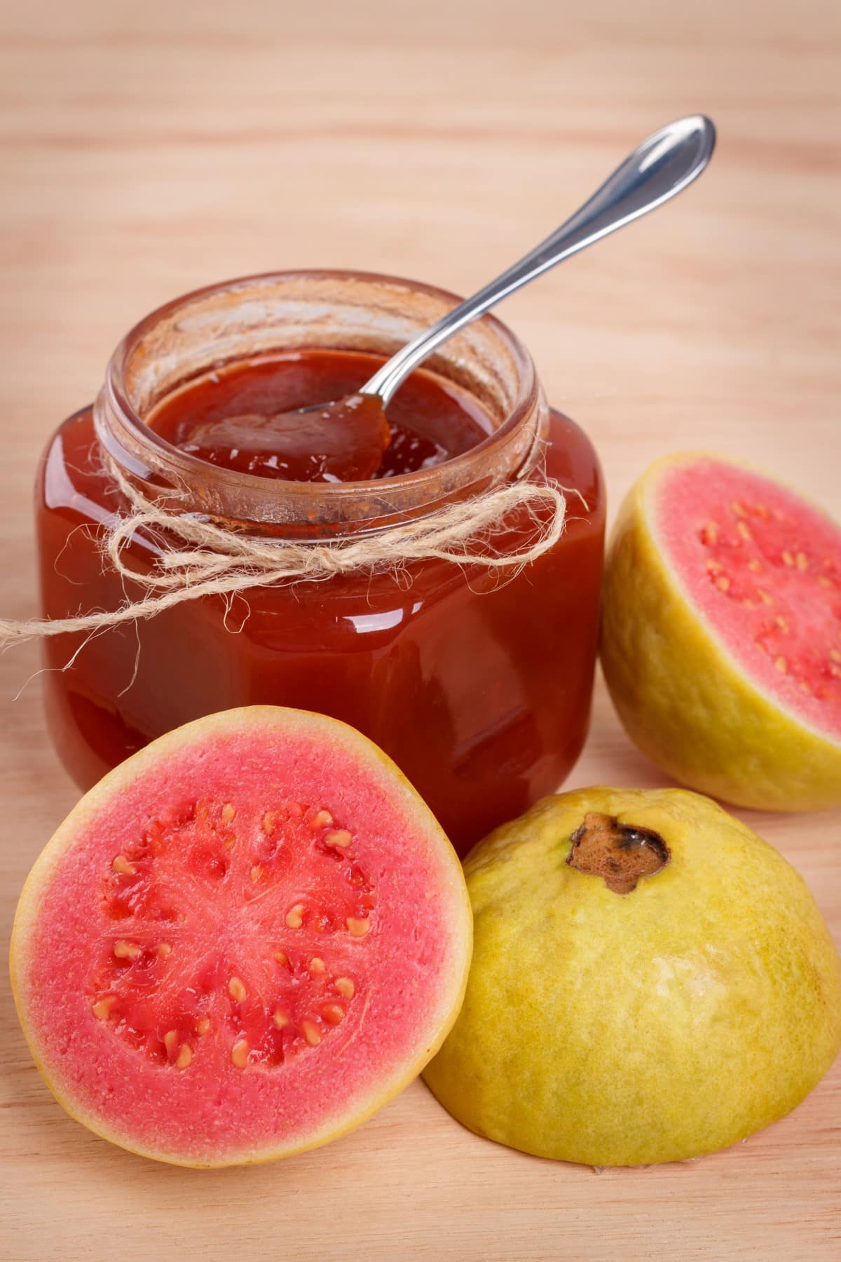 Guava jam plus sliced ripe fruit.