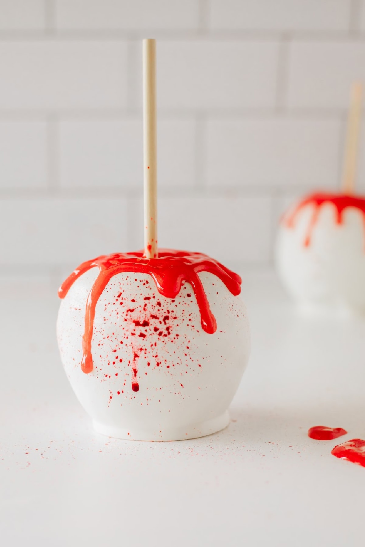 White chocoalte covered apple covered with red food coloring gel to look like blood. 