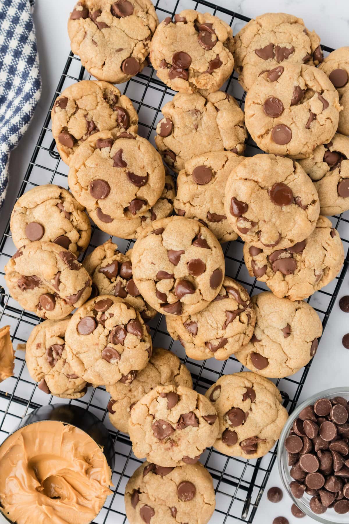 Overhead shot of Peanut Butter Chocolate Chip Cookies on a cooling rack stacked on each other. 