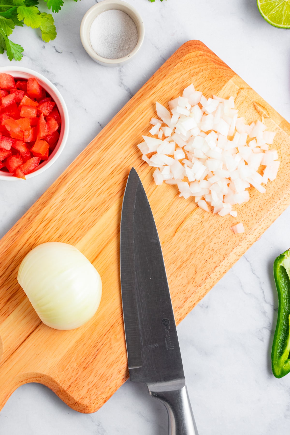 Chopping onion on a chopping board.