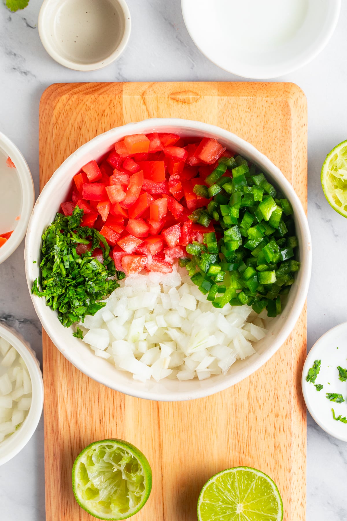 Mixing Pico de gallo ingredients in a bowl.