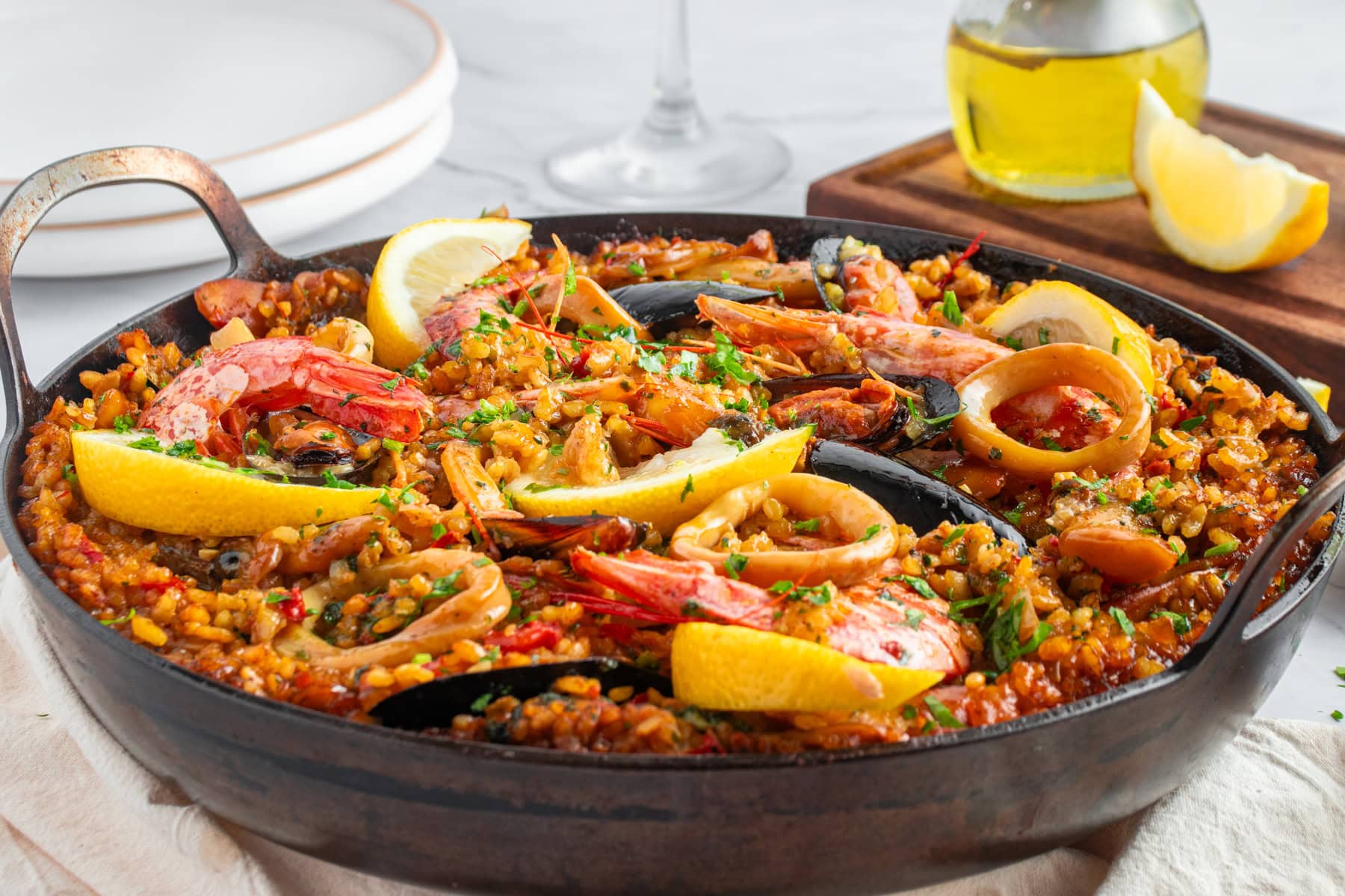 Seafood Paella in a paella pan ready to serve. Horizontal front view shot. 