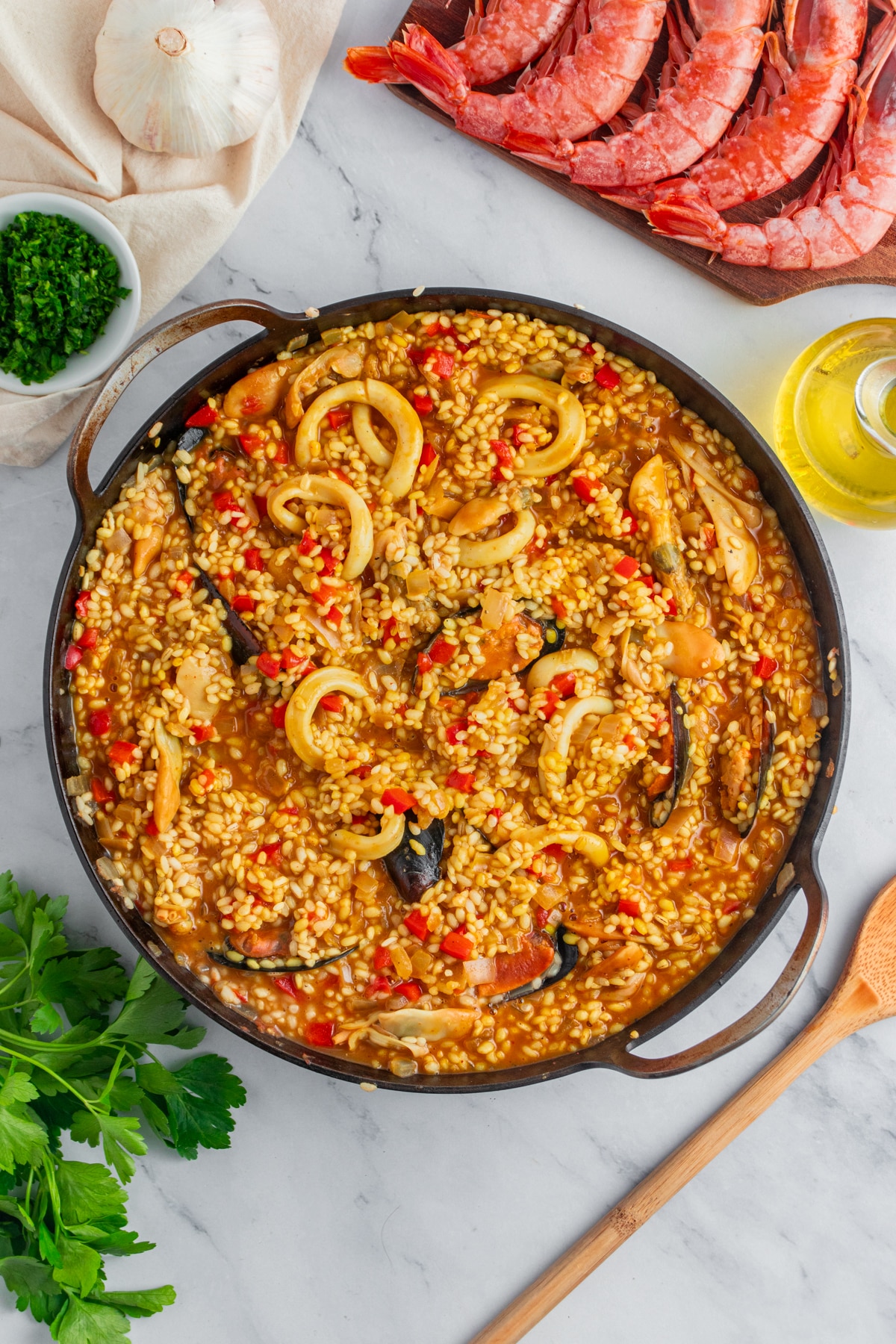 Rice being infused in a seafood paella.