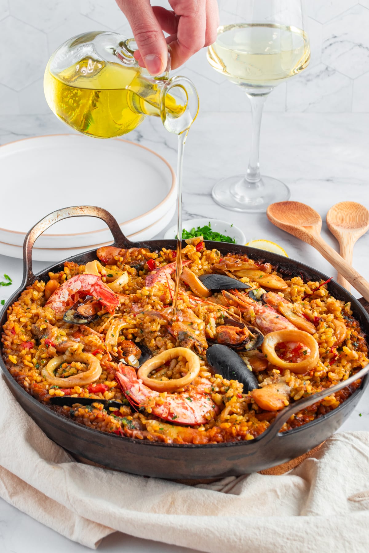 Add a drizzle of olive oil before serving seafood paella.