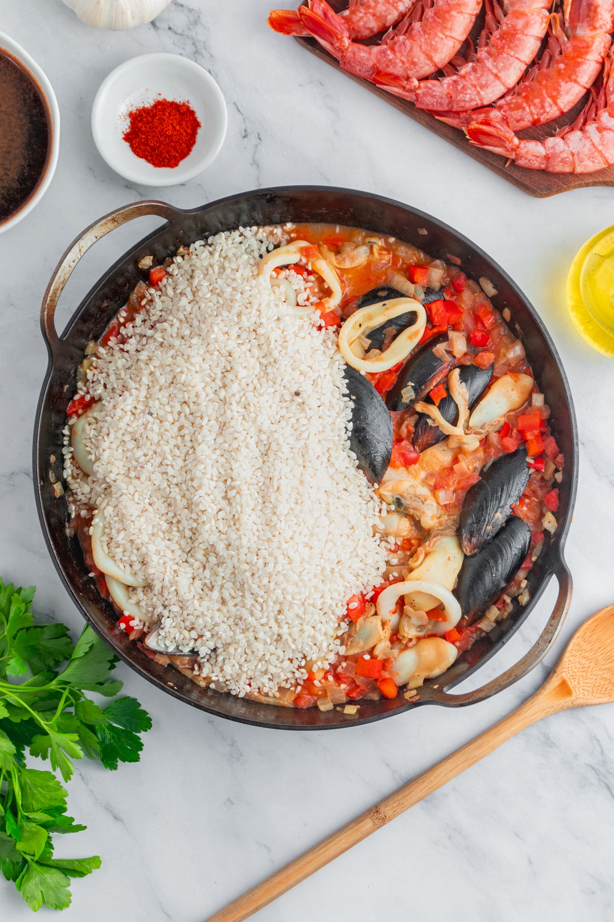 Adding rice to the paella.