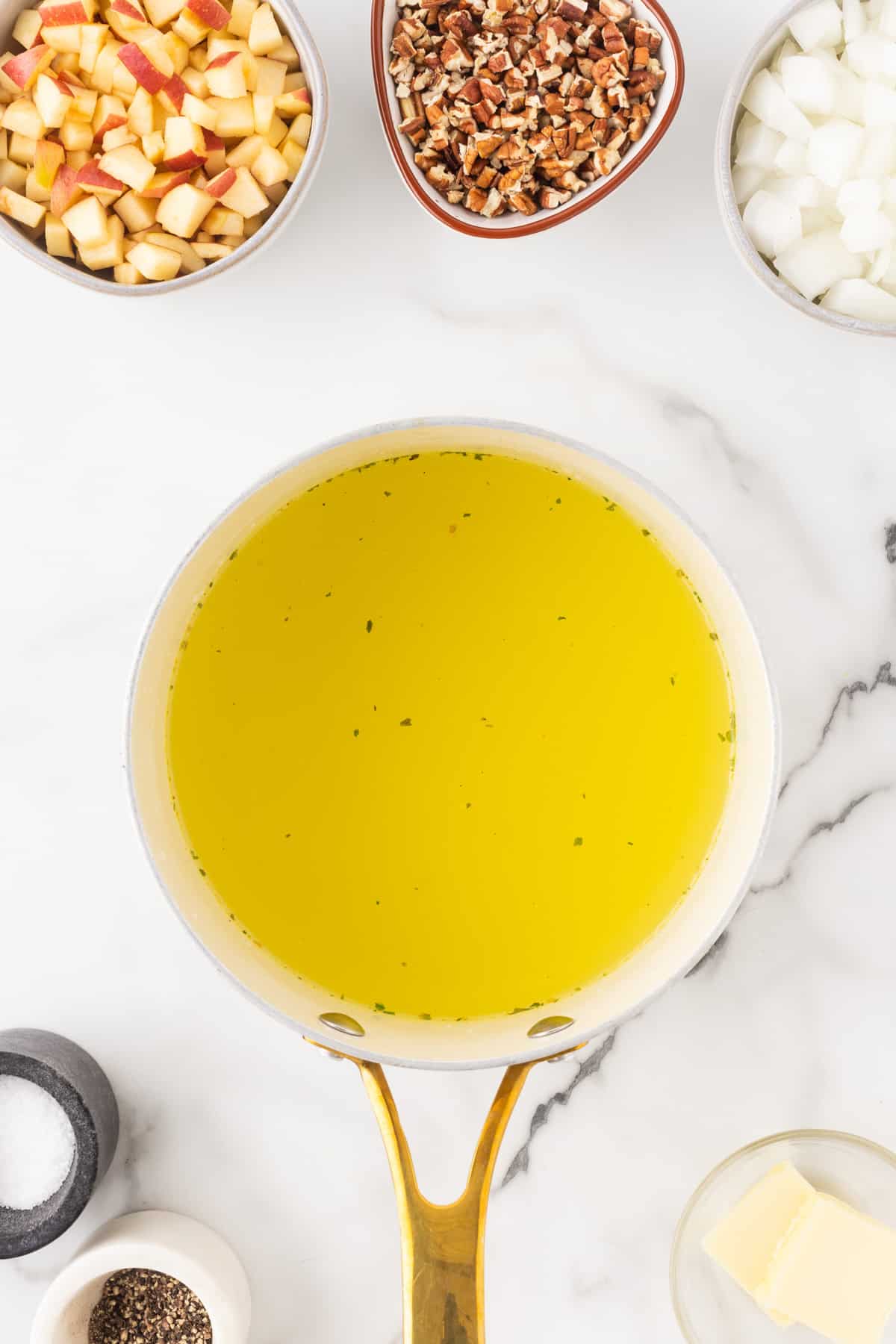 Chicken broth in a small pot.