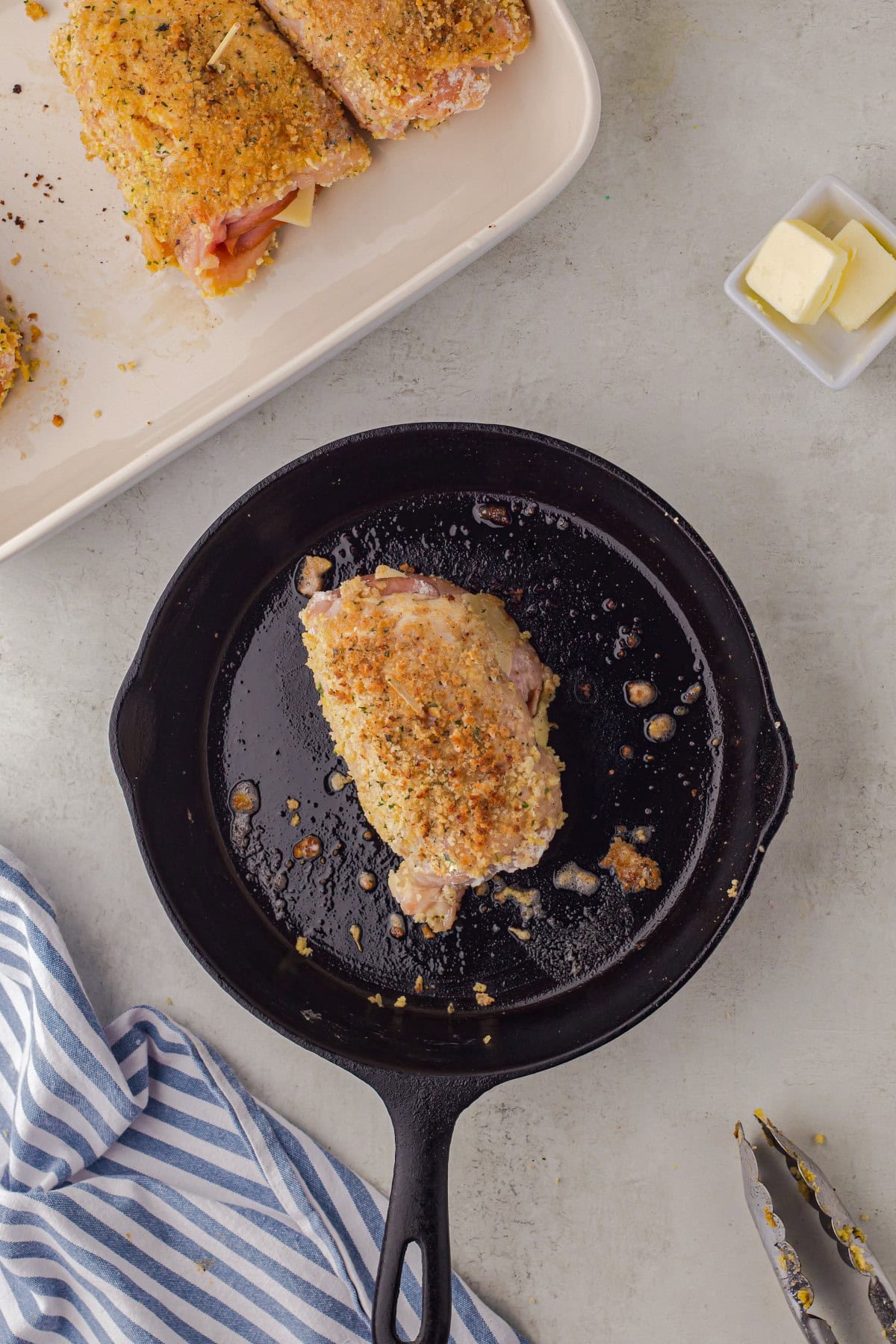 Frying up the rolled chicken breast.