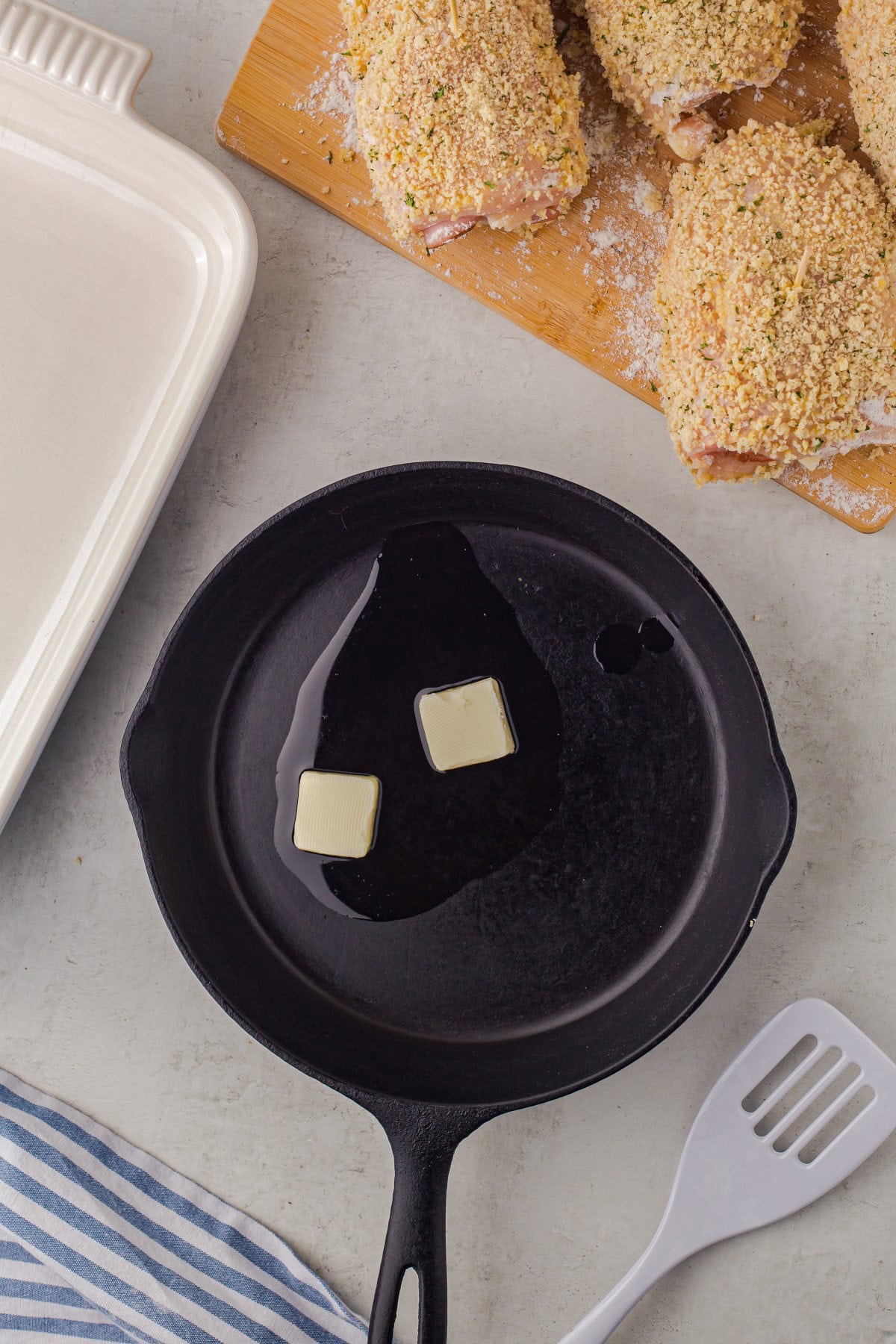 Two pats of butter and oil in a cast iron pan. 