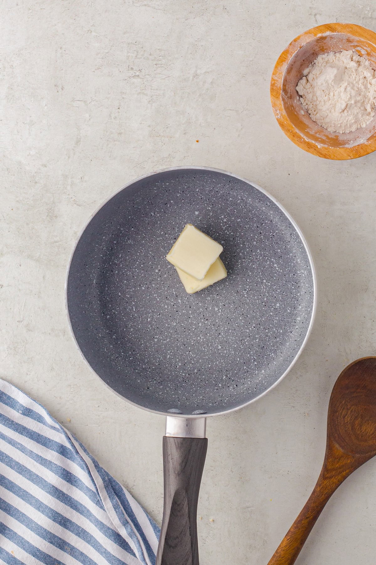 Two pats of butter in a saute pan. 