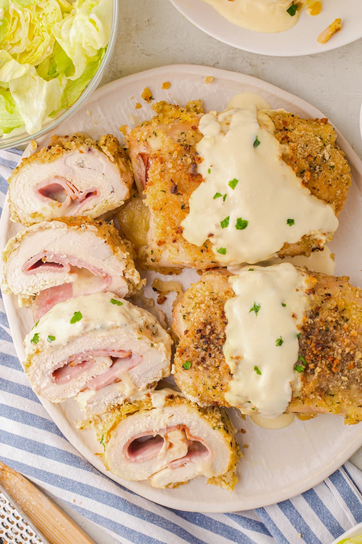 Sliced and whole chicken cordon bleu served on a platter. 