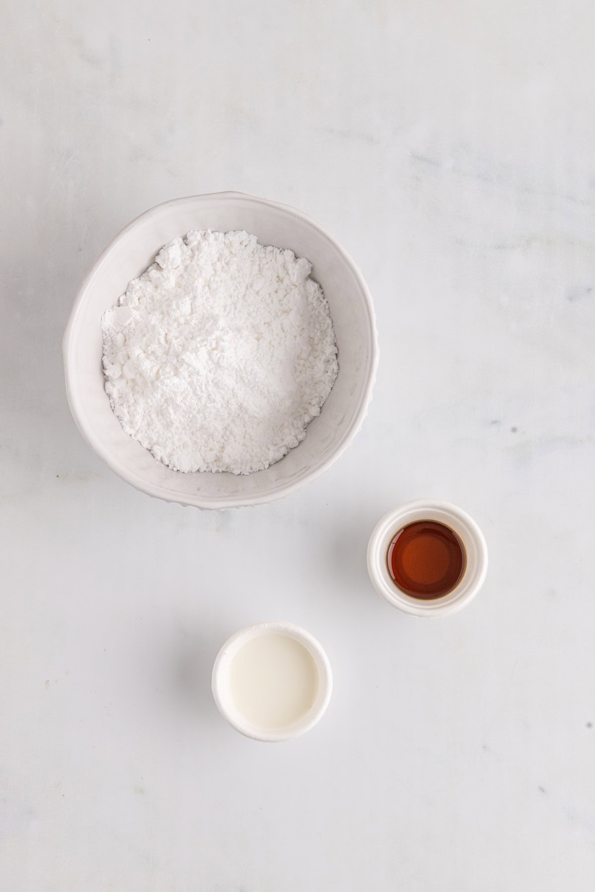 Icing ingredients in separate bowls. 