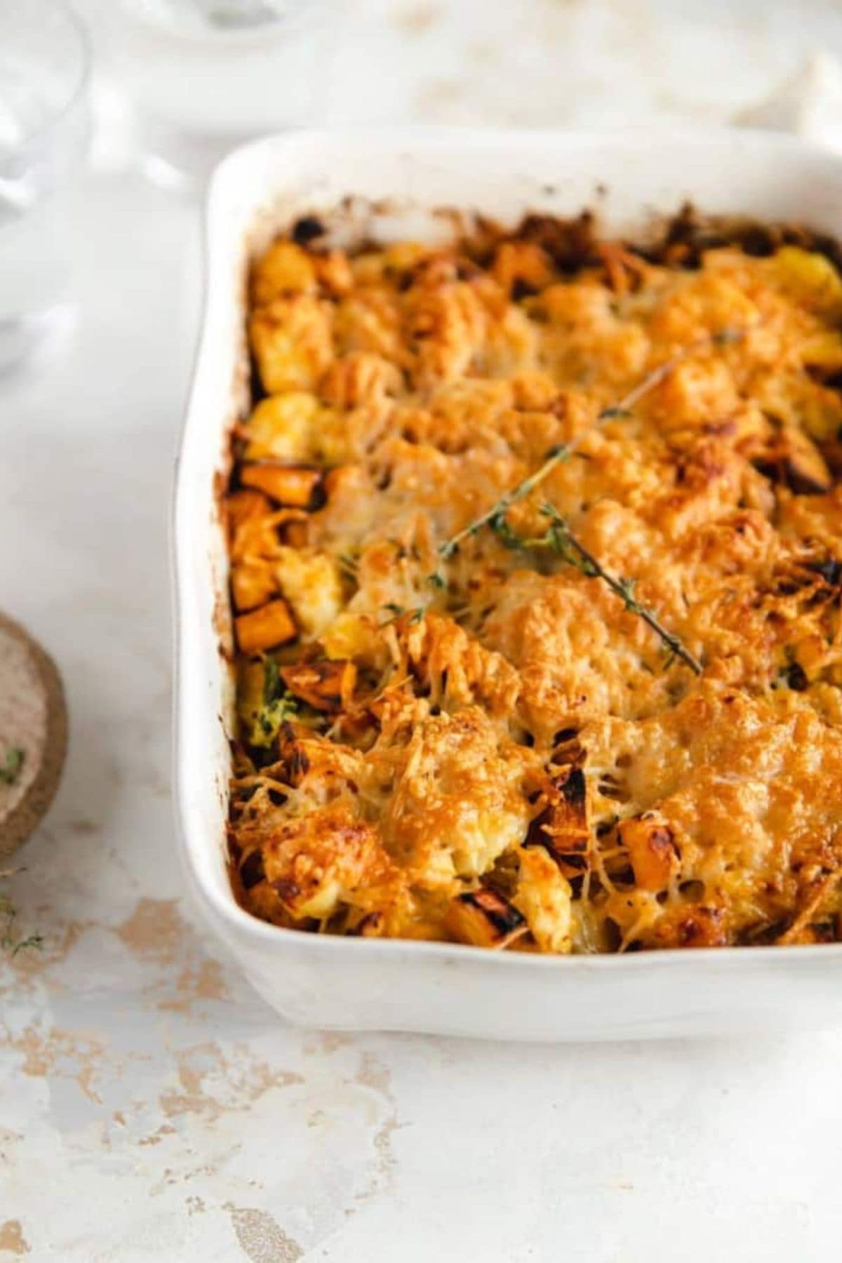 Creamy pumpkin casserole in a casserole dish on a counter.