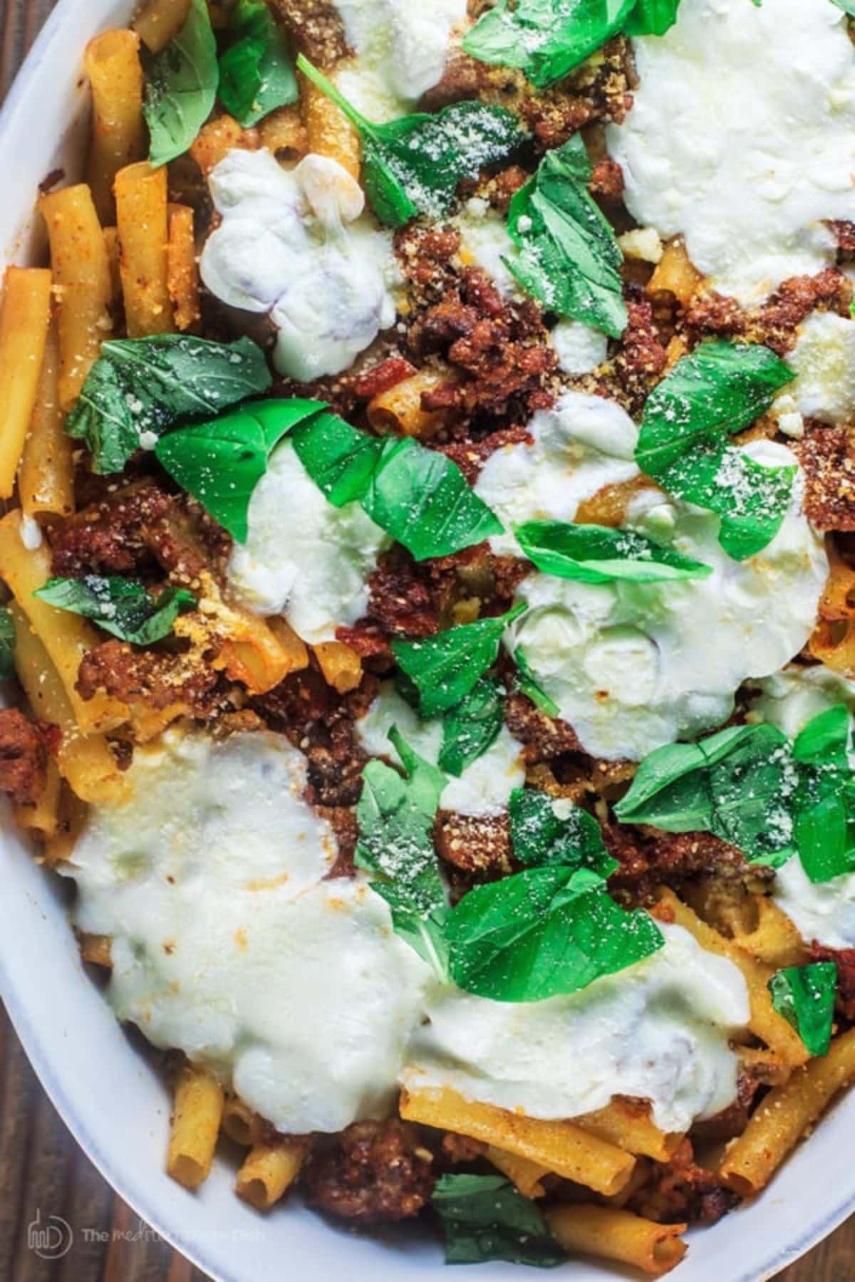 Uncut easy baked ziti on the table in a casserole dish.