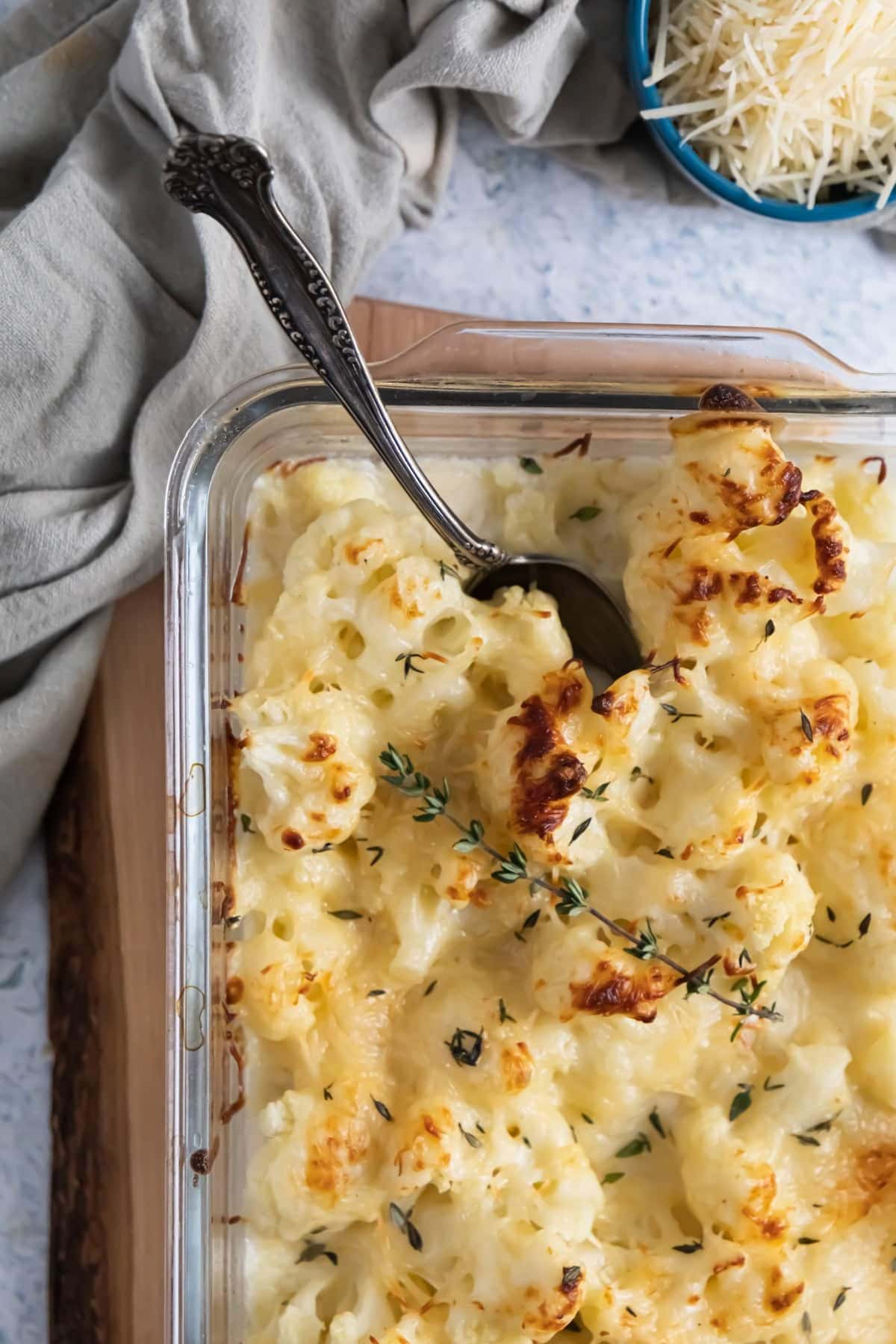 Glass casserole dish filled with loaded cauliflower casserole.