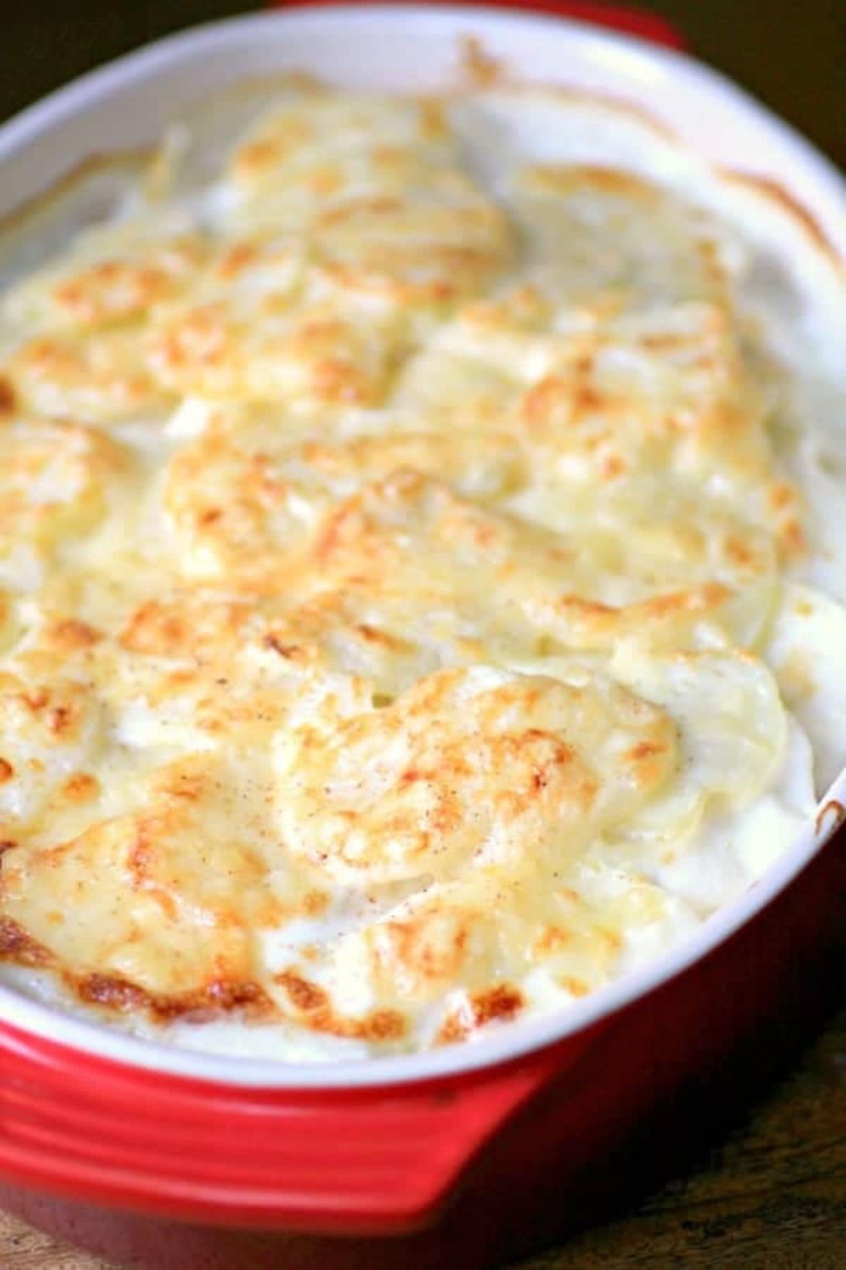 Oval casserole dish filled with potatoes dauphinoise.