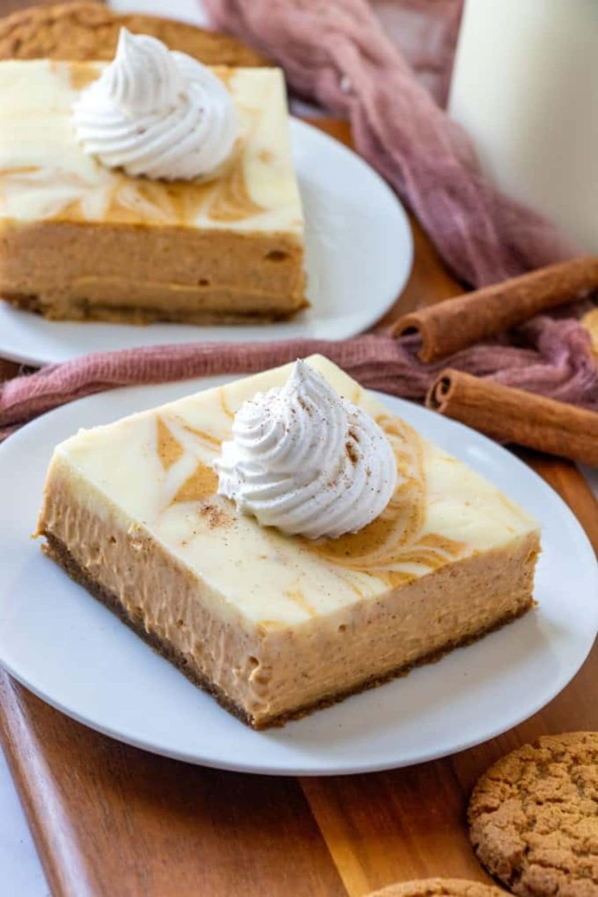 Slice of pumpkin swirl cheesecake bars on a small plate.