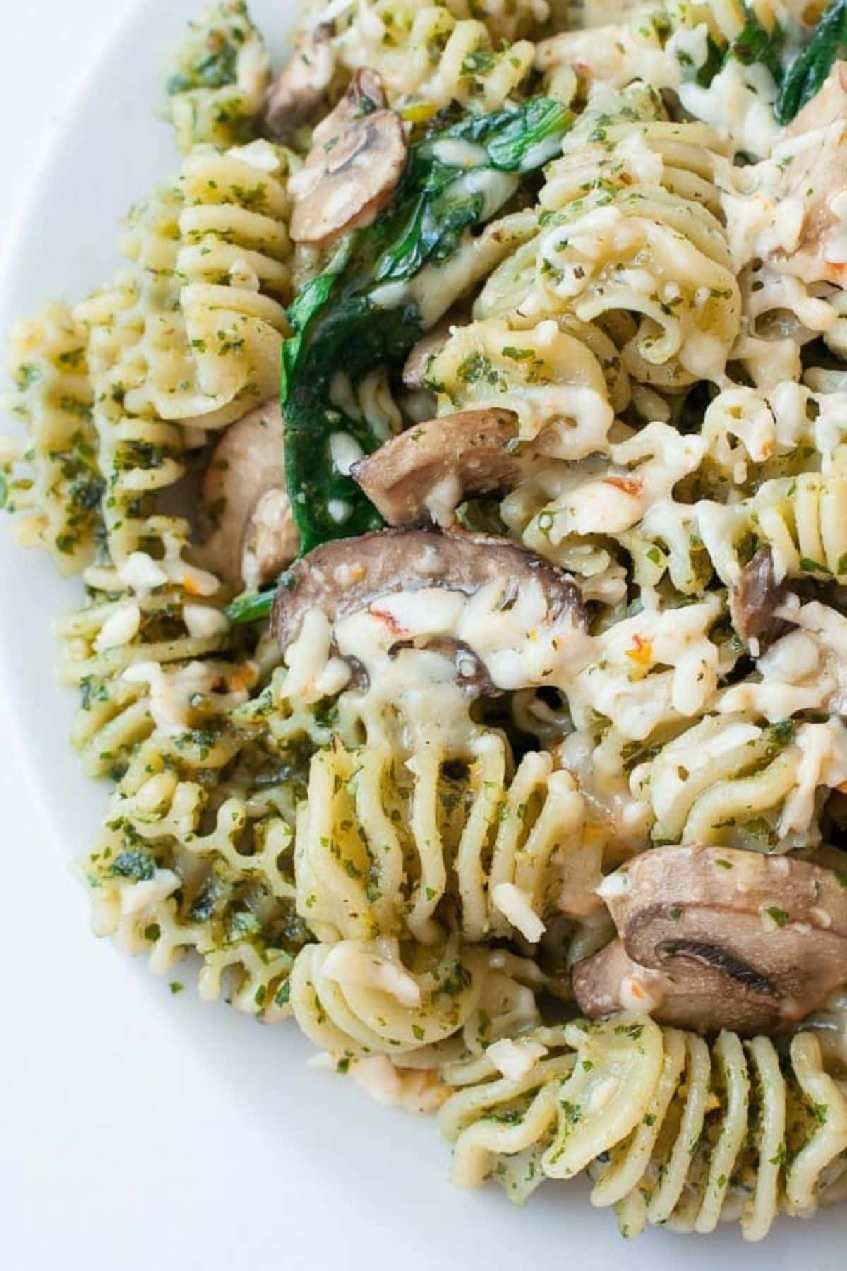 Plate of roasted garlic kale pesto and veggie pasta ready to serve.