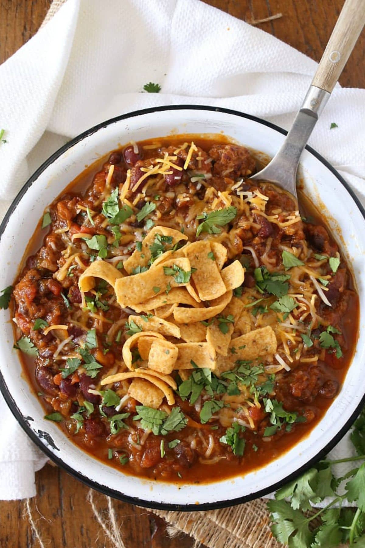 Bowl full of slow cooker pumpkin chili topped with corn chips.