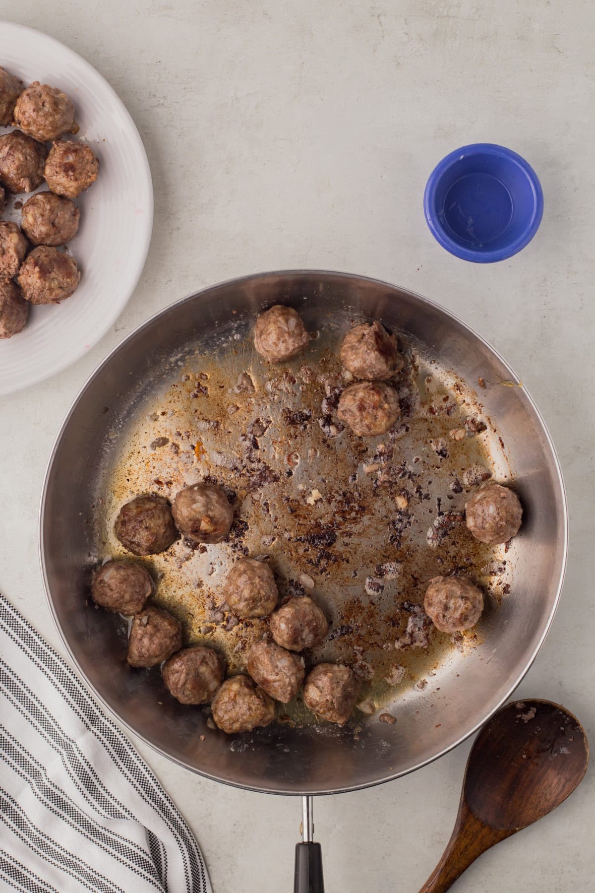 Frying  up meatballs in batches. 